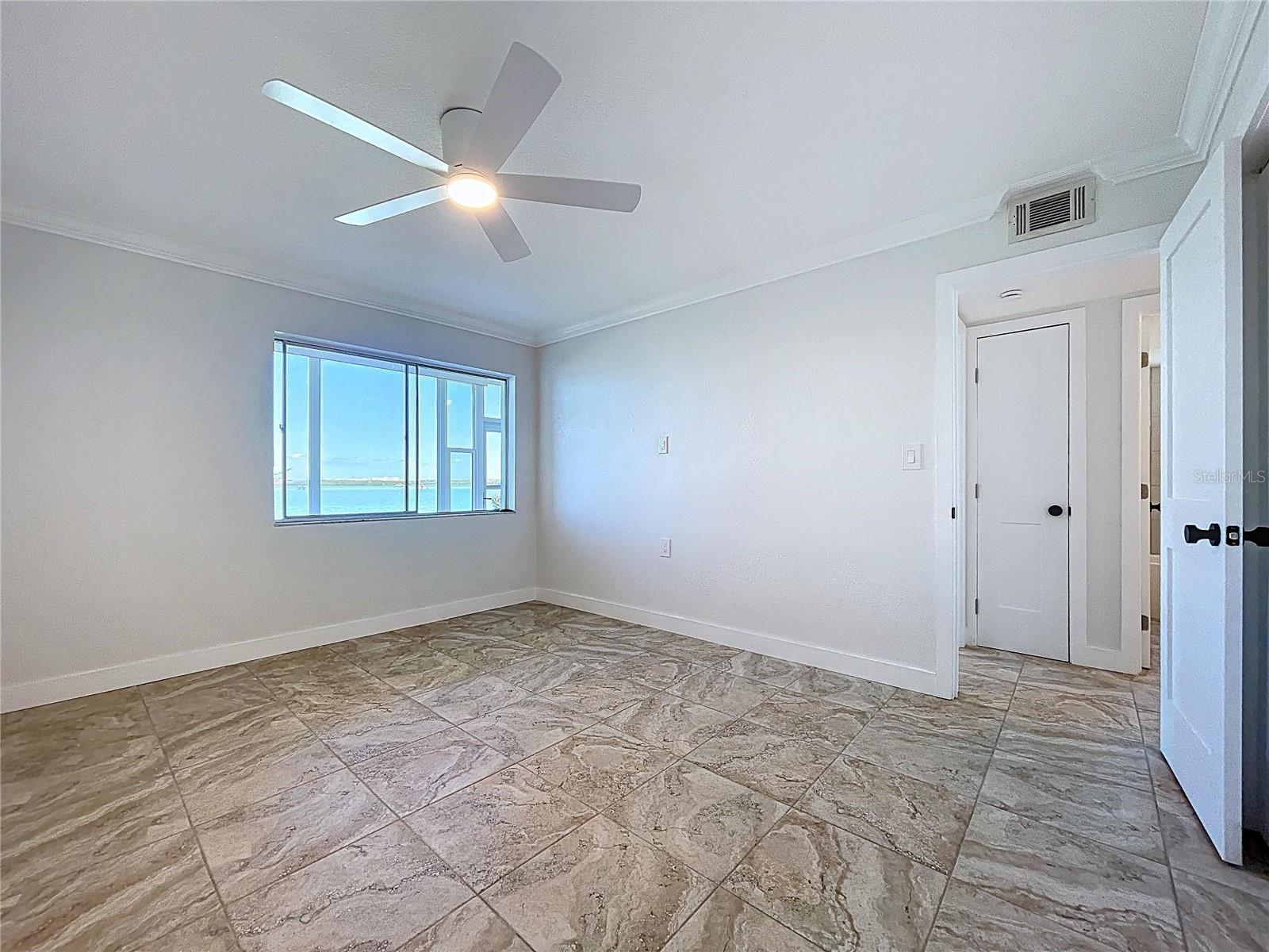 The Primary bedroom offers views of the waterways of John's Pass.
