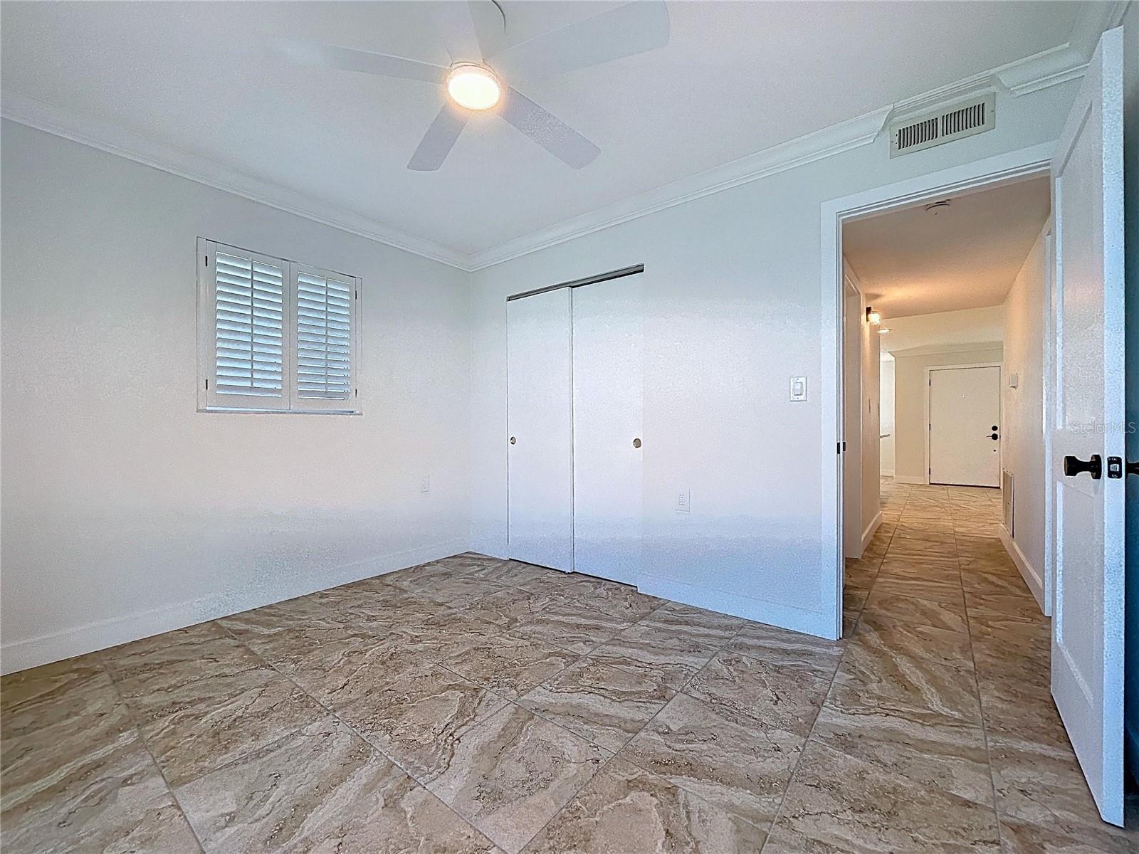 The guest bedroom is a great flex space in this condo.