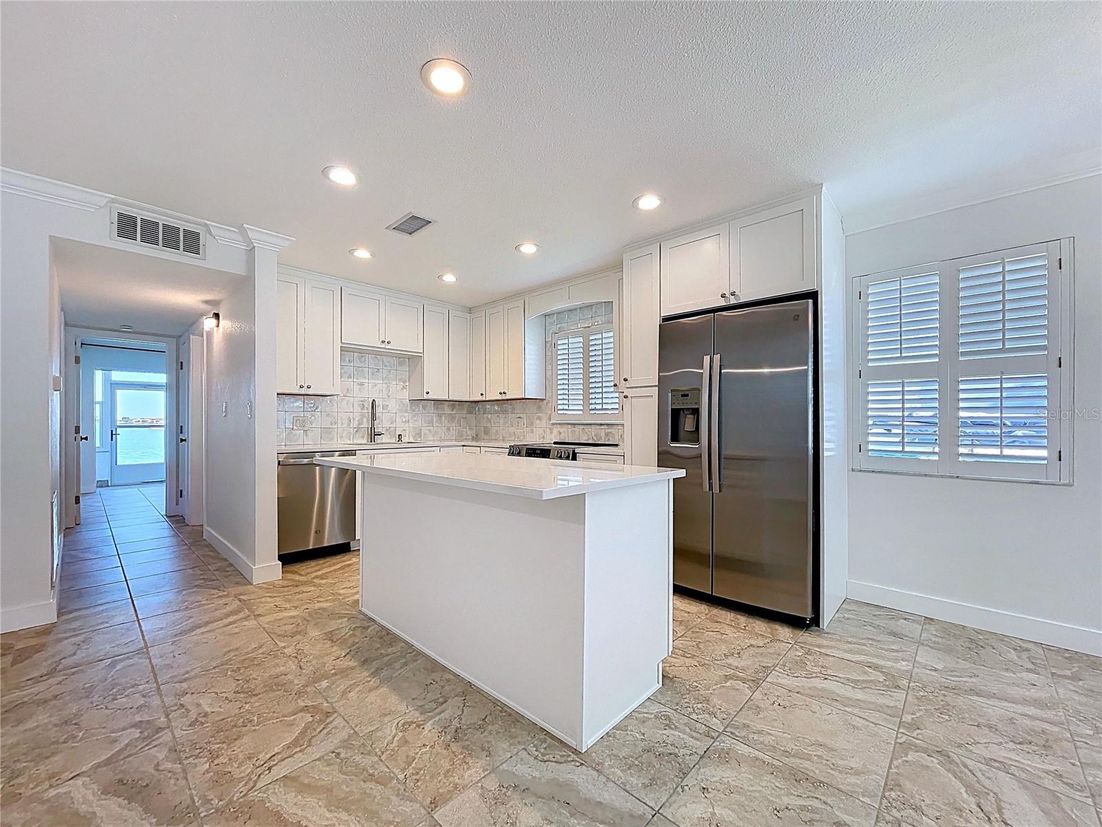 Fully updated kitchen offers all new cabinets and SS appliances.