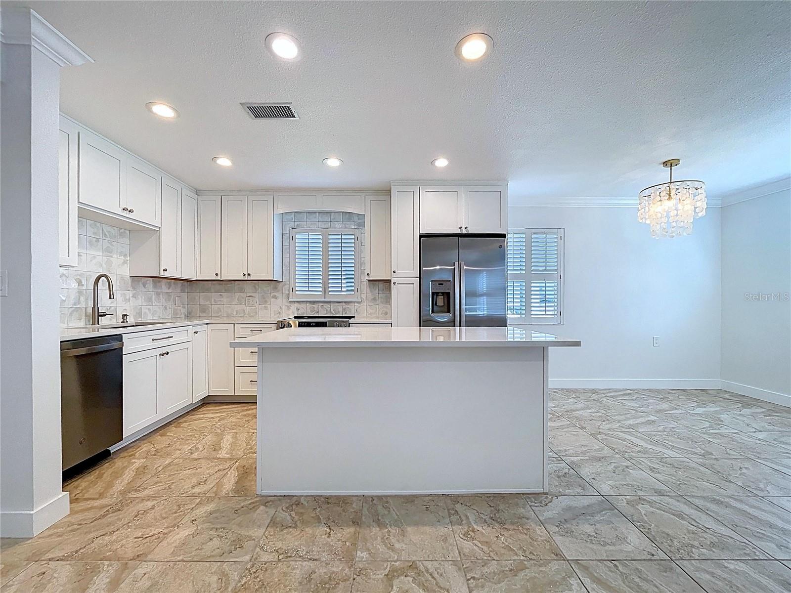 Fully updated kitchen offers all new cabinets and SS appliances.