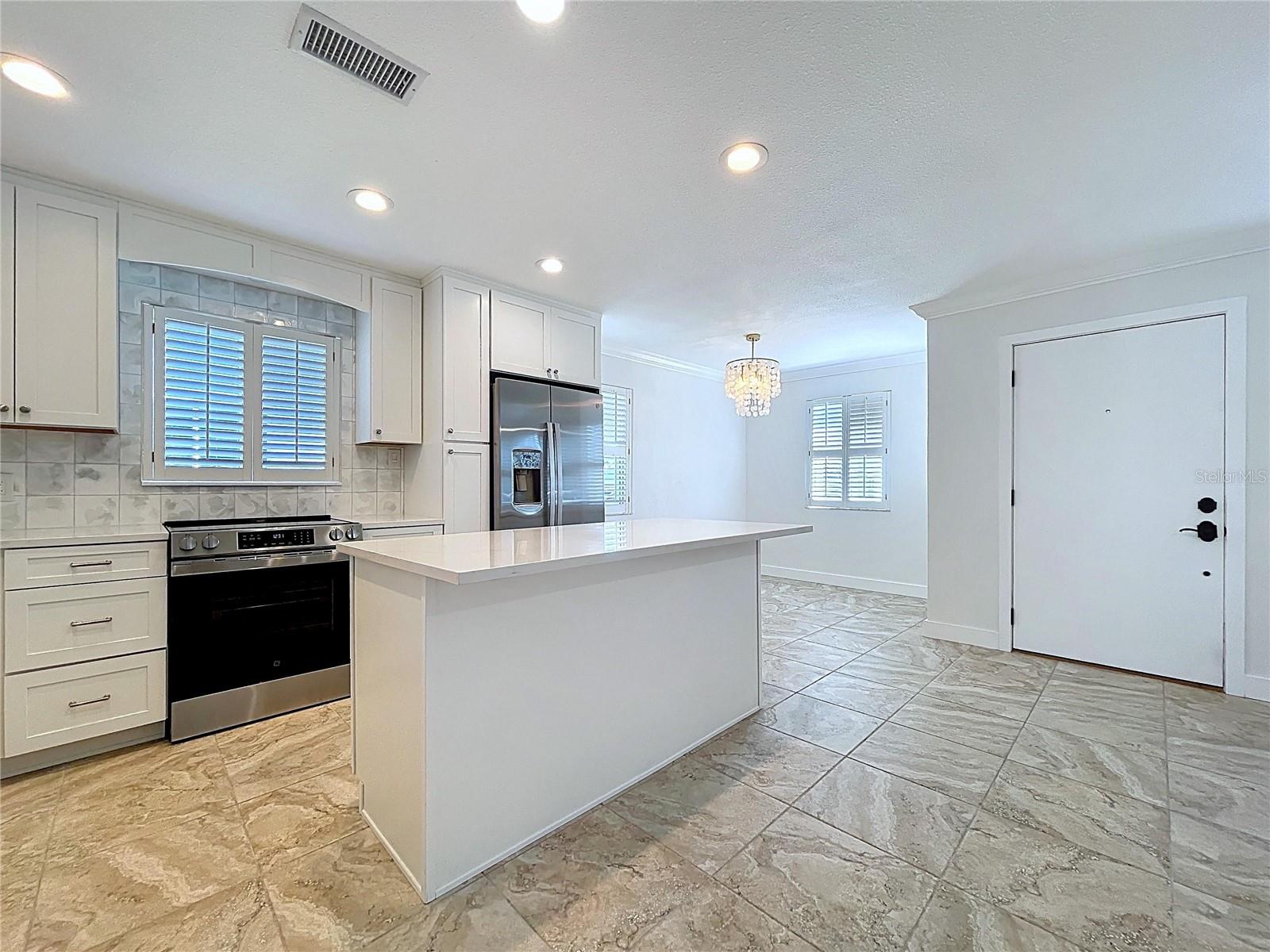 Fully updated kitchen offers all new cabinets and SS appliances.