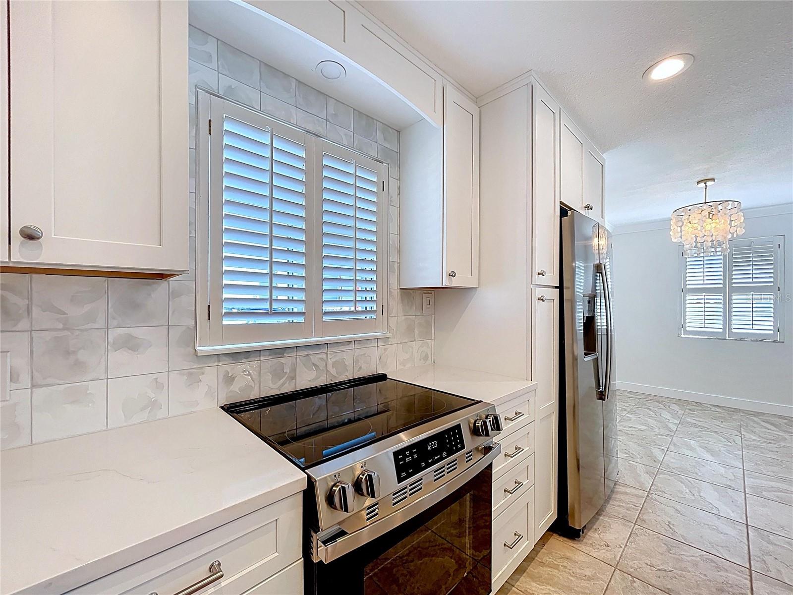 Fully updated kitchen offers all new cabinets and SS appliances.