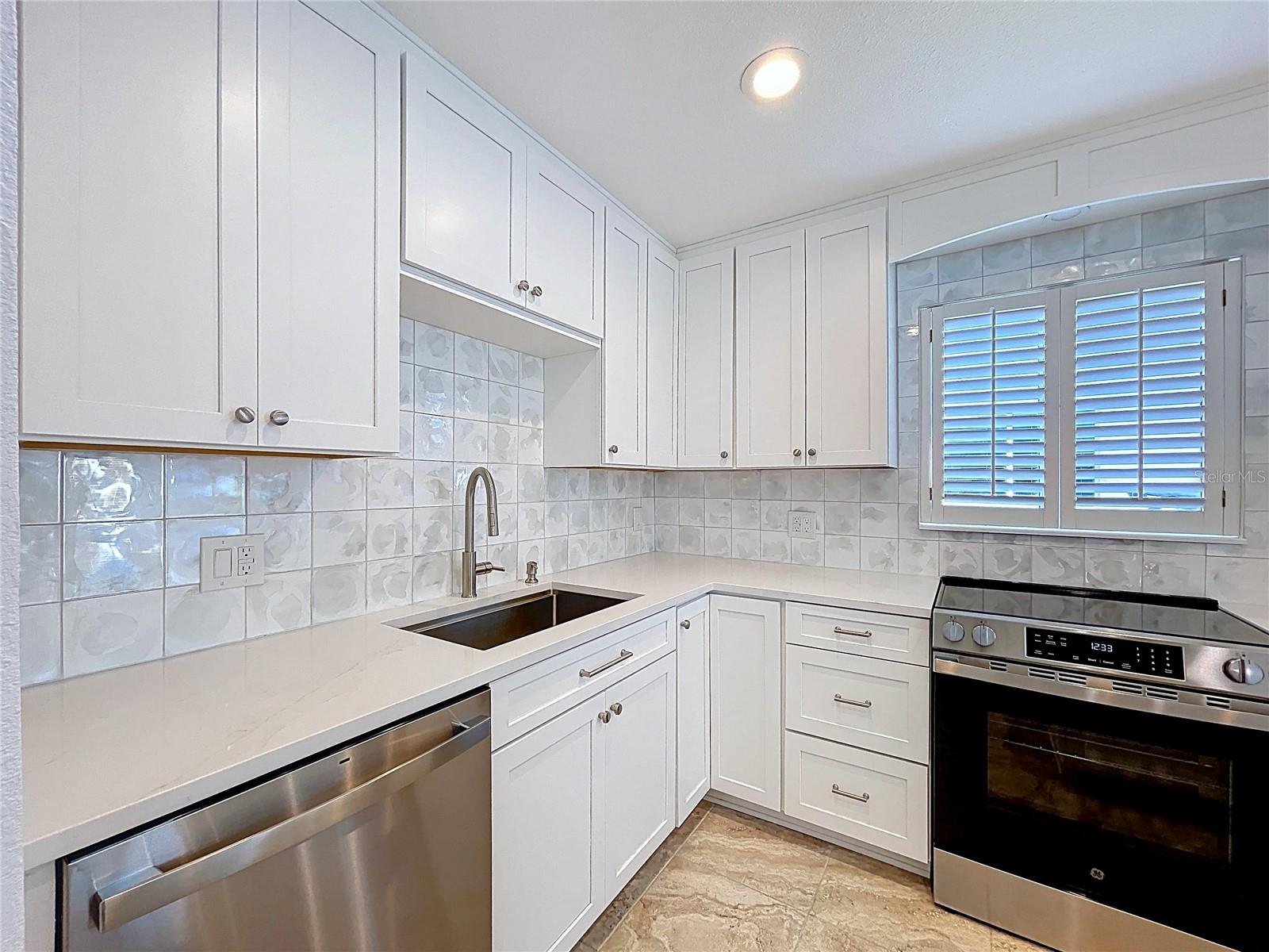 Fully updated kitchen offers all new cabinets and SS appliances.