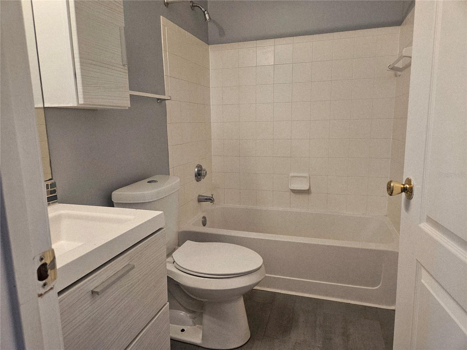 guest bath with entrances to hall and 2nd bedroom