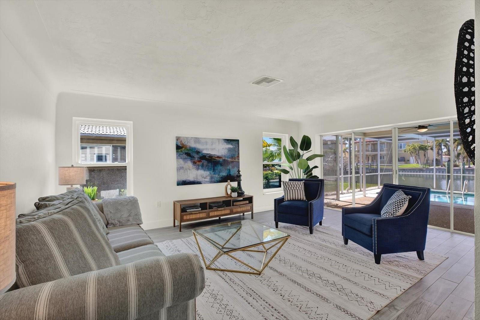 Formal Living Room with pool and water view