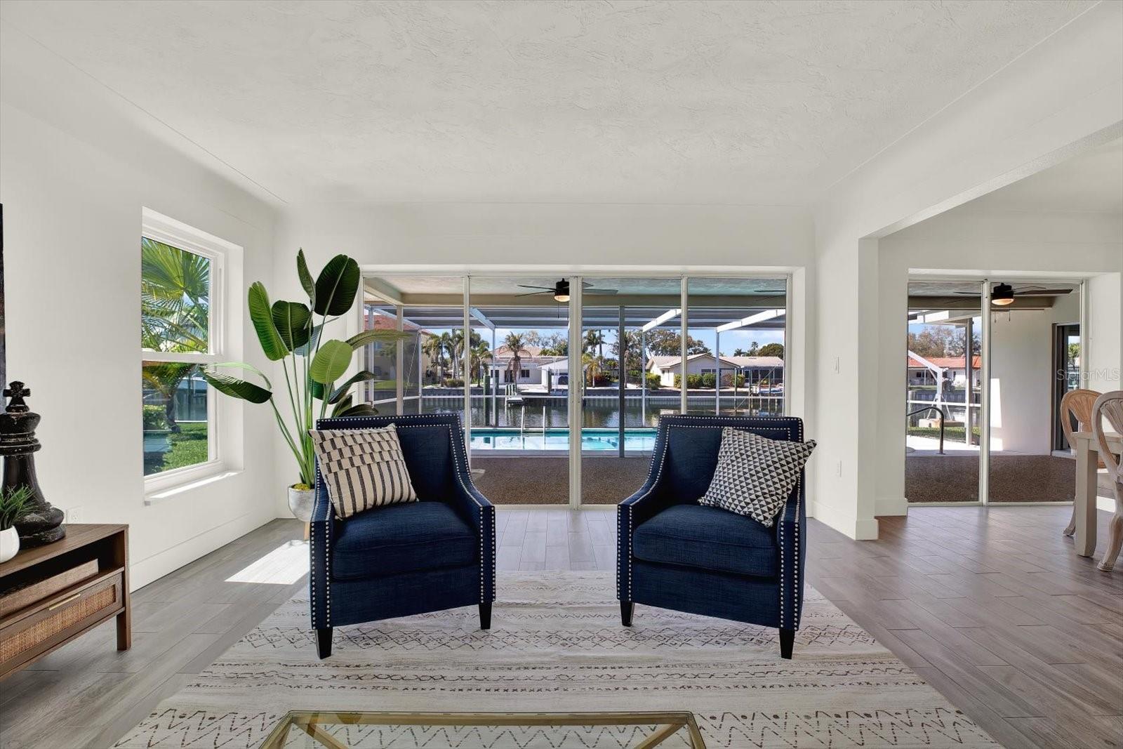 Formal Living Room with pool and water view