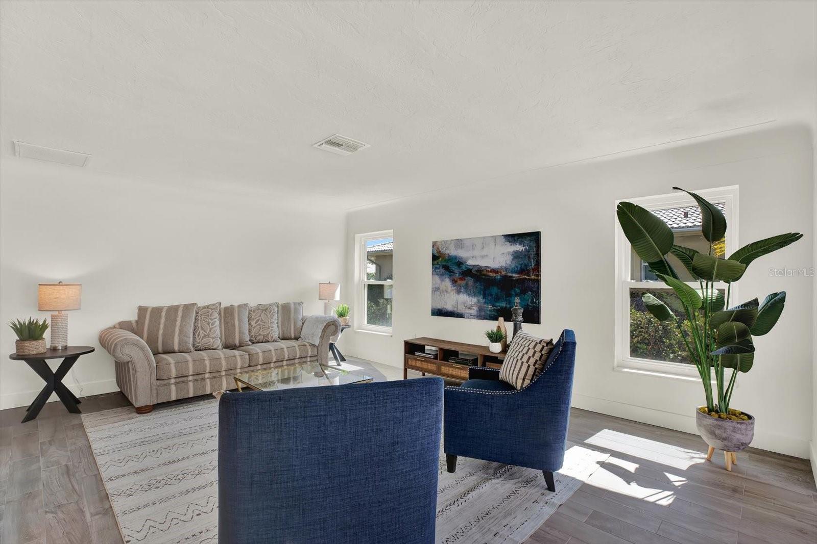 Formal Living Room with pool and water view