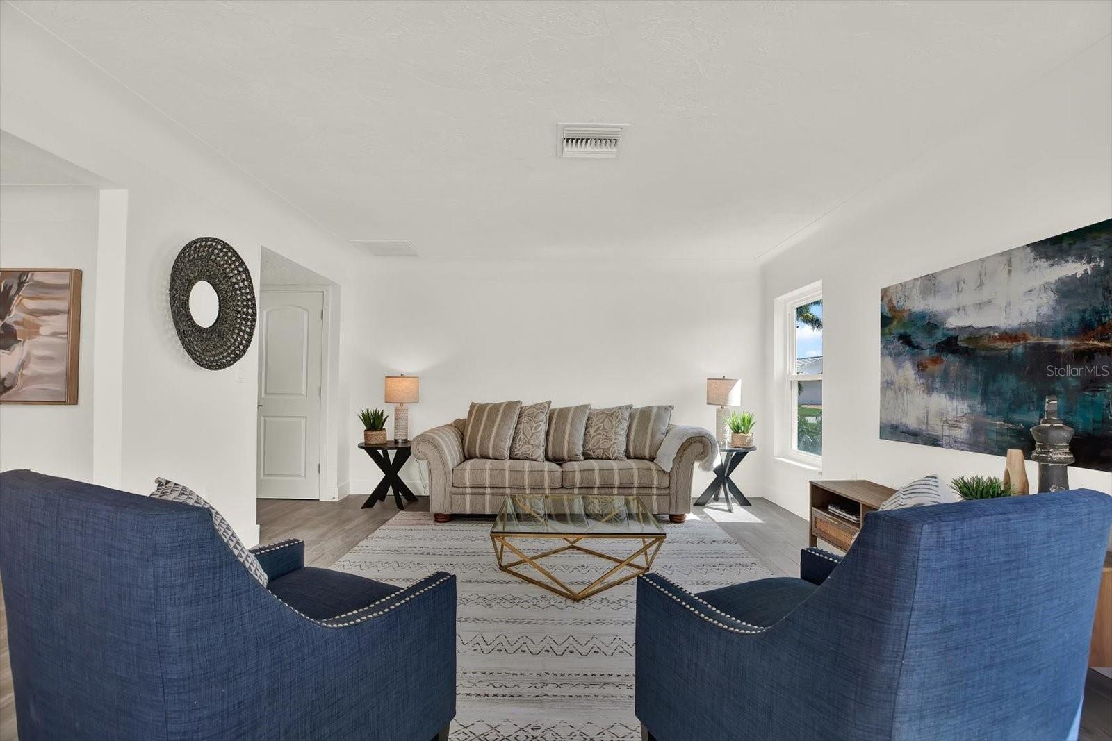 Formal Living Room with pool and water view