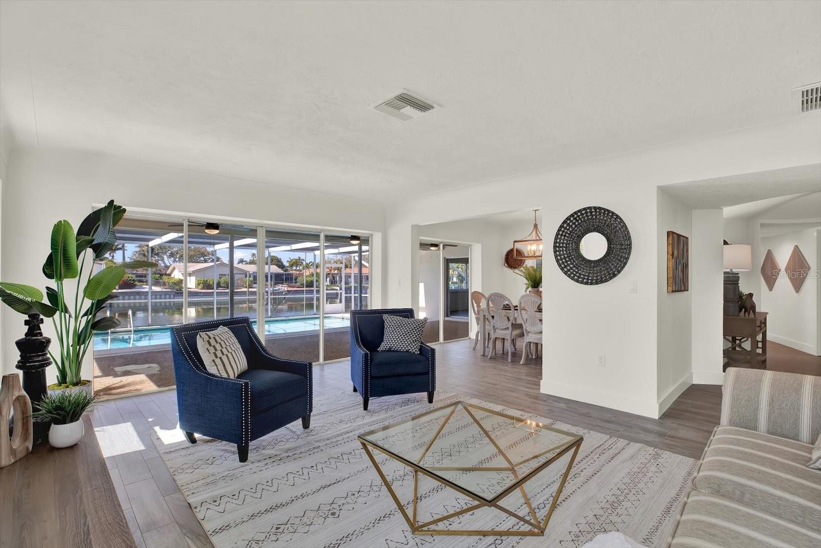 Formal Living Room with pool and water view