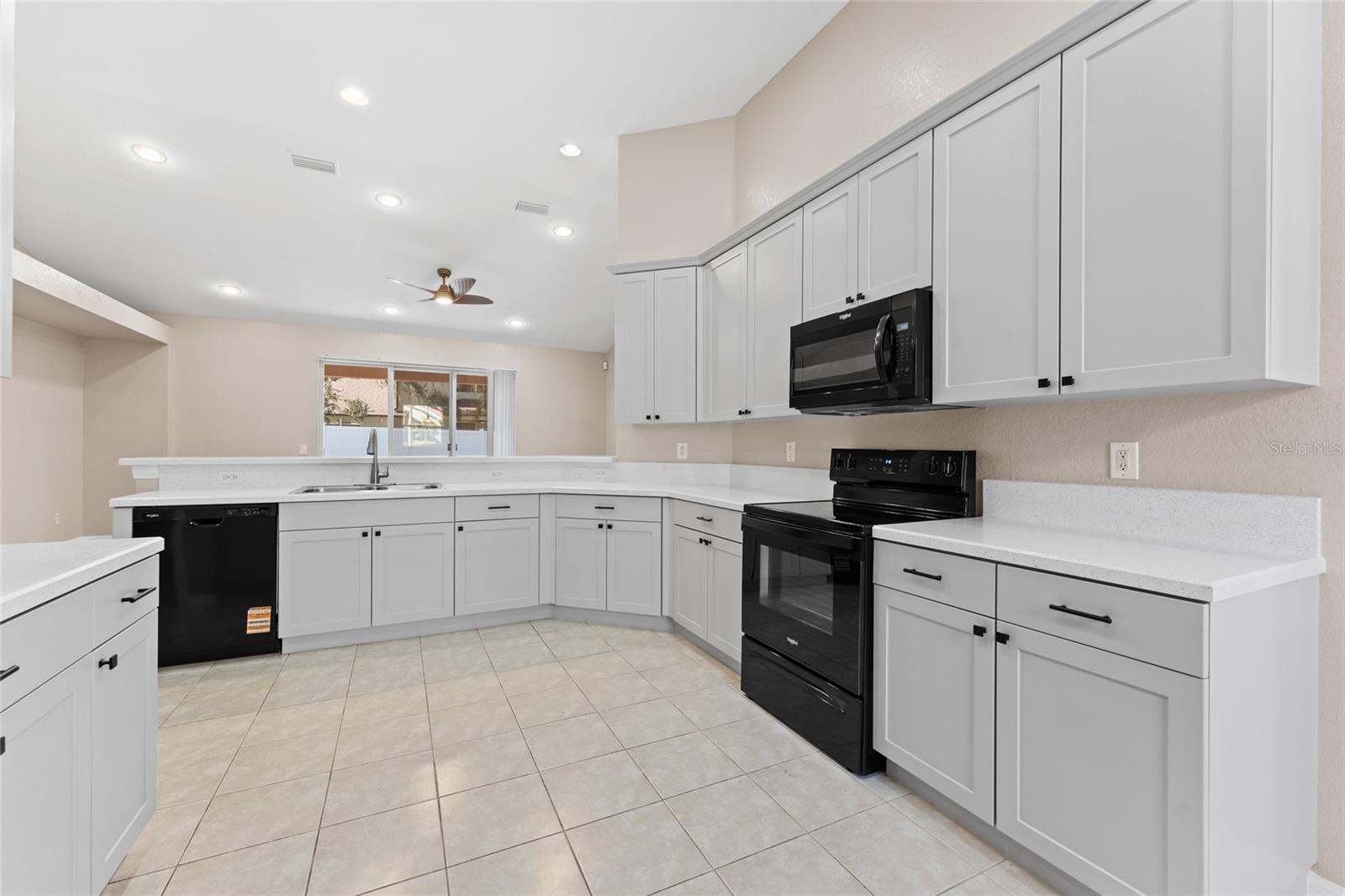 Freshly painted cabinetry and new appliances
