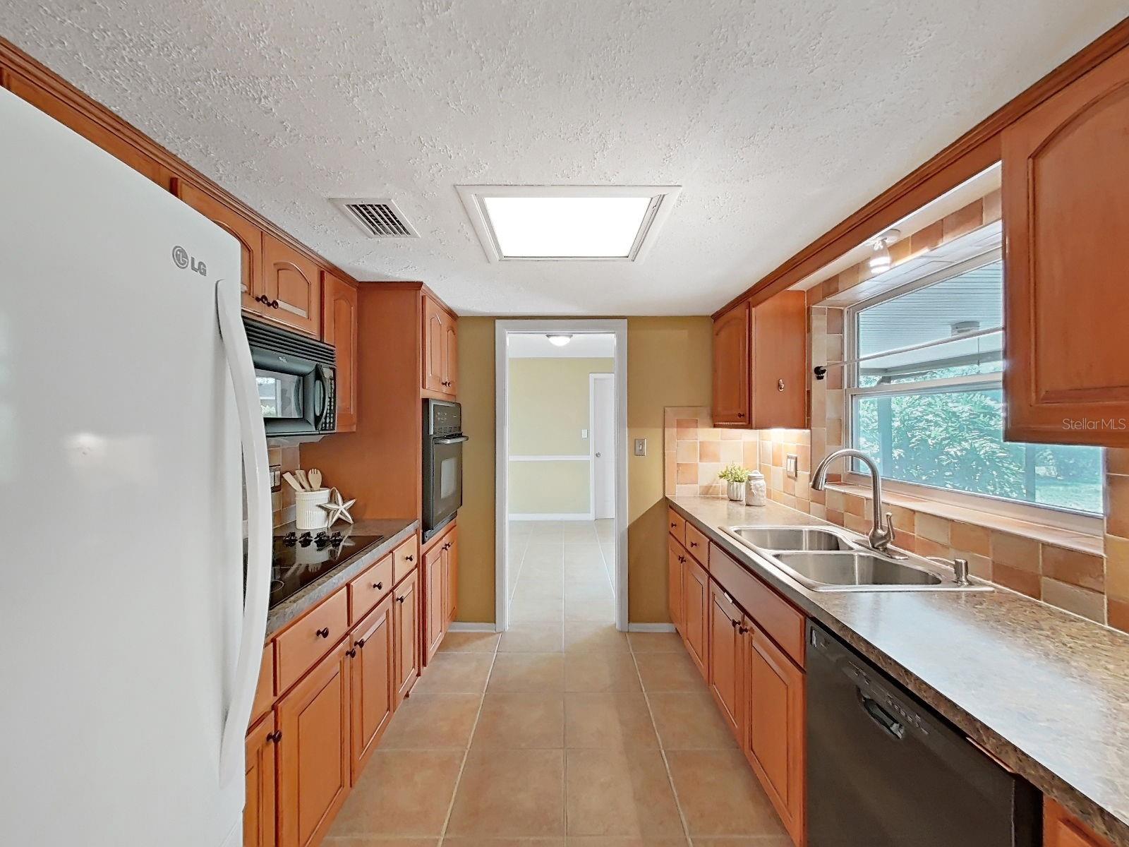 This kitchen is the heart of the home, a true central connection to all areas.