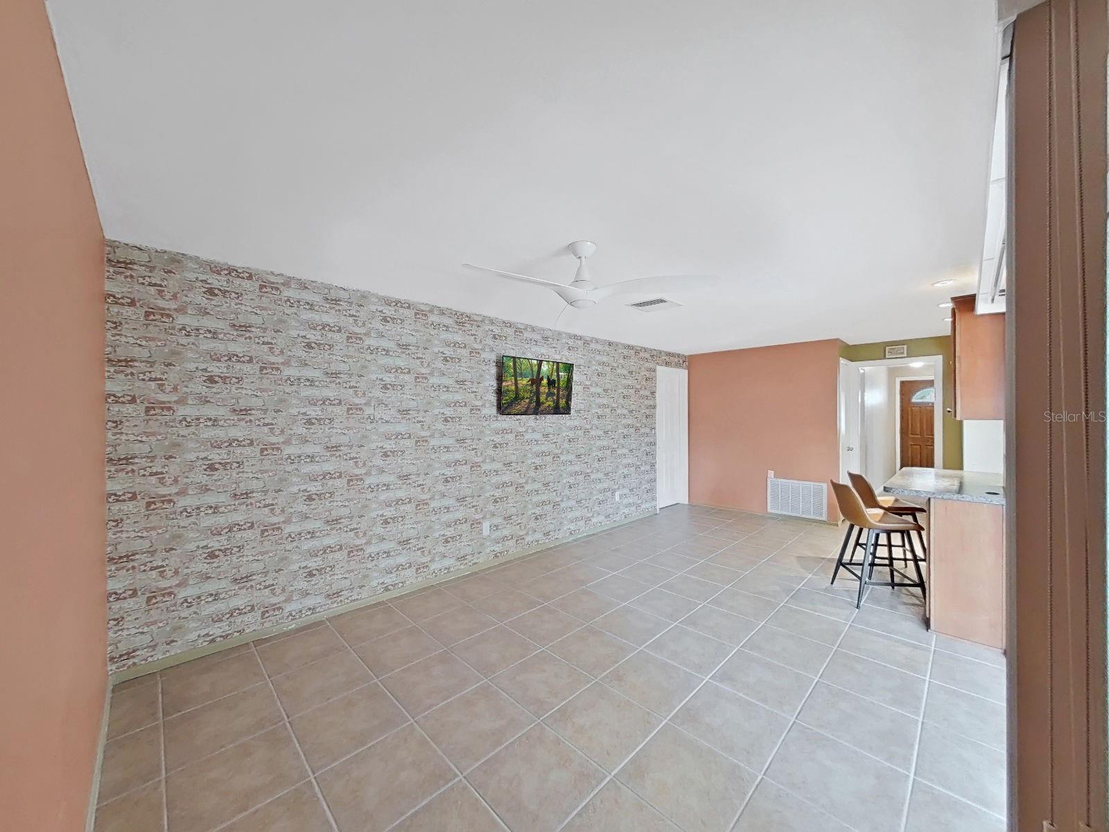 Back inside the family room, the primary suite is through the far door.