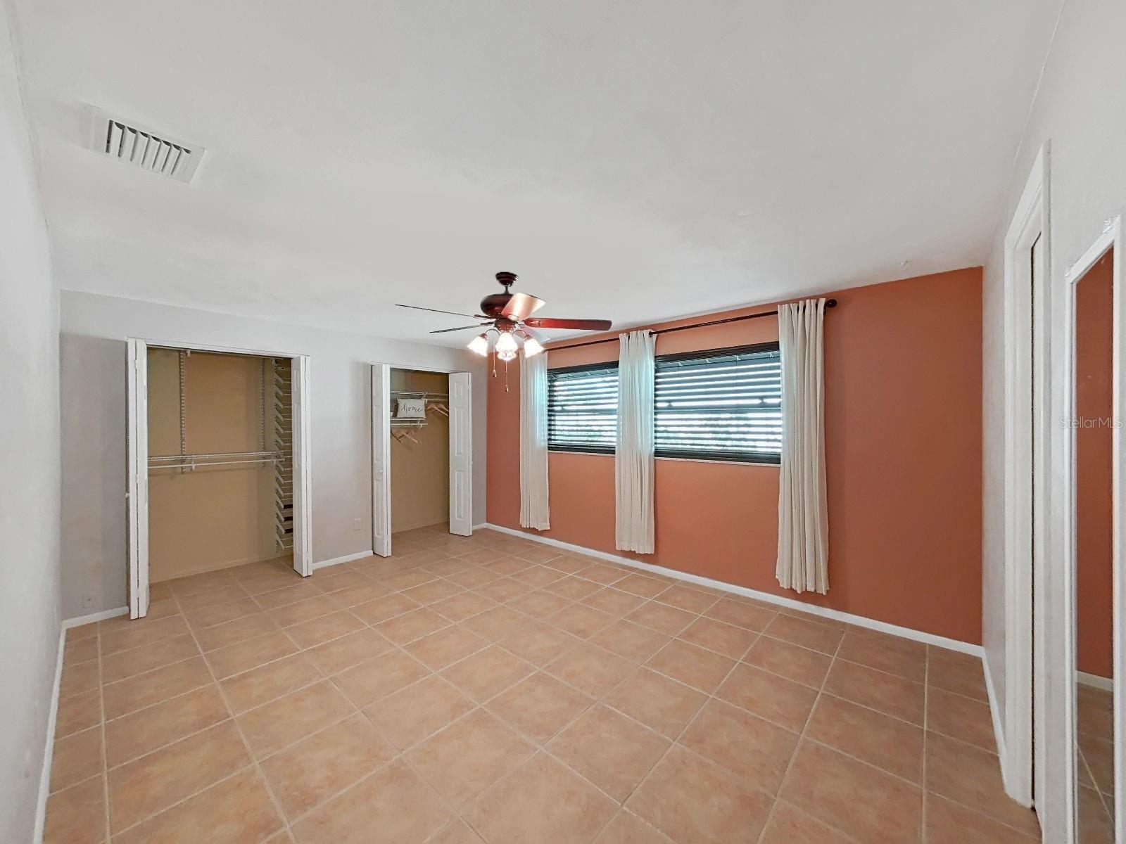 Super spacious Primary Suite with dual closets, new impact-rated vinyl double-hung windows, and private en suite bathroom.