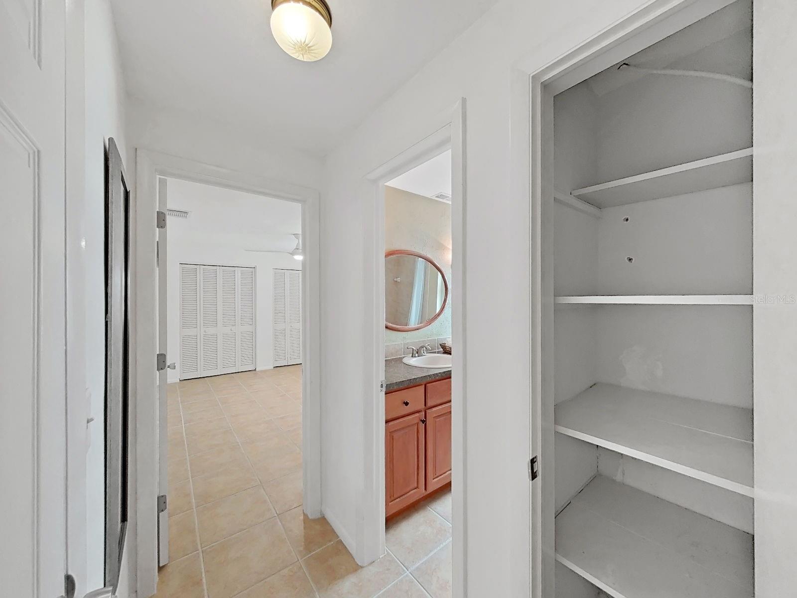 Entrance hallway to the second bedroom suite, with a pocket door to gracefully section off this wing.