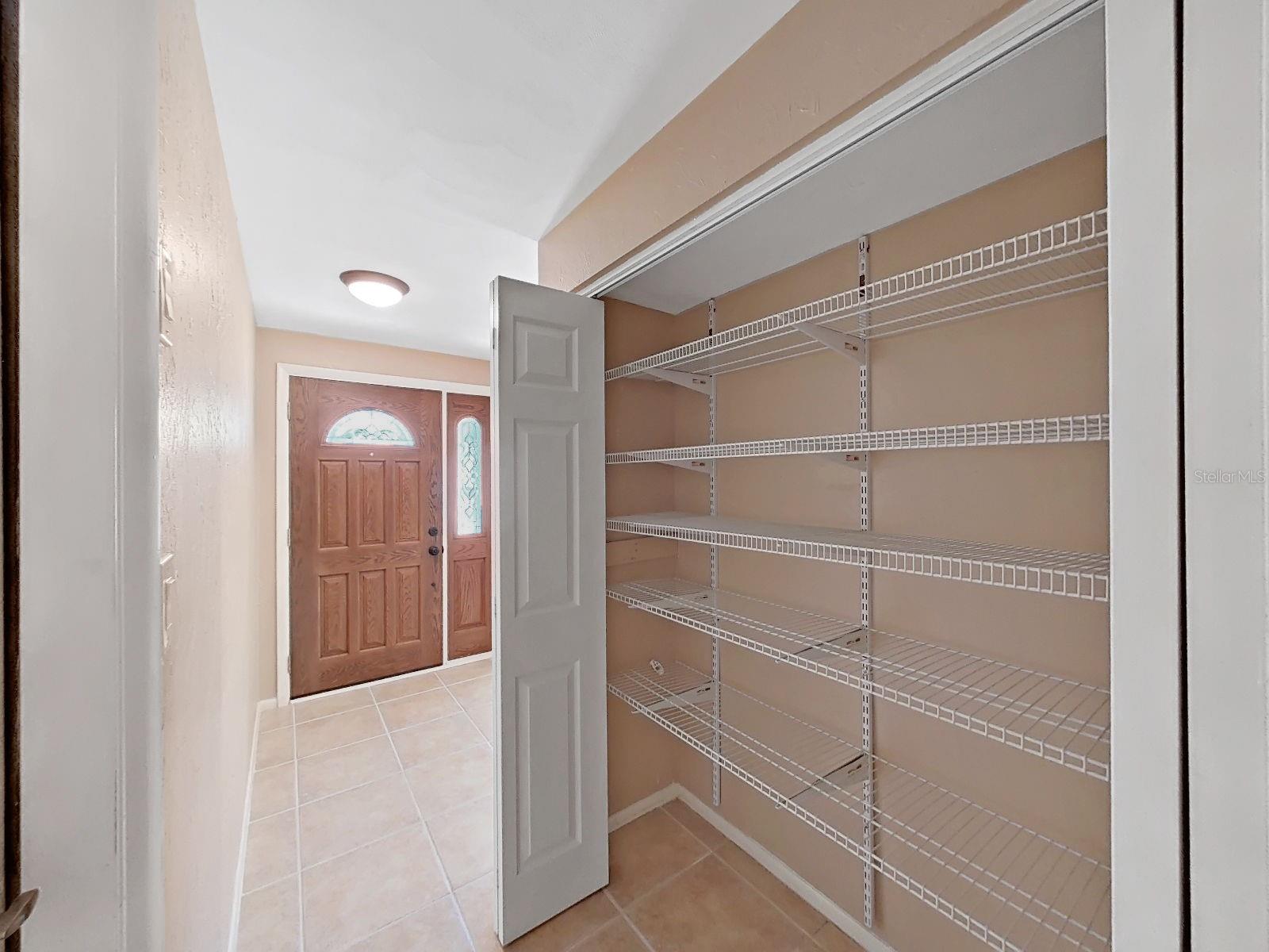 Spacious storage closet off of the foyer area with floor to ceiling adjustable shelving for abundant storage & keeping everything organized & accessible.