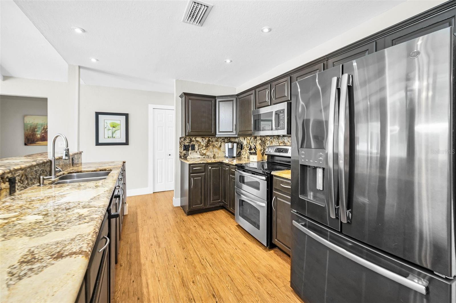 Kitchen w/ Granite countertops and newer stainless steel appliances