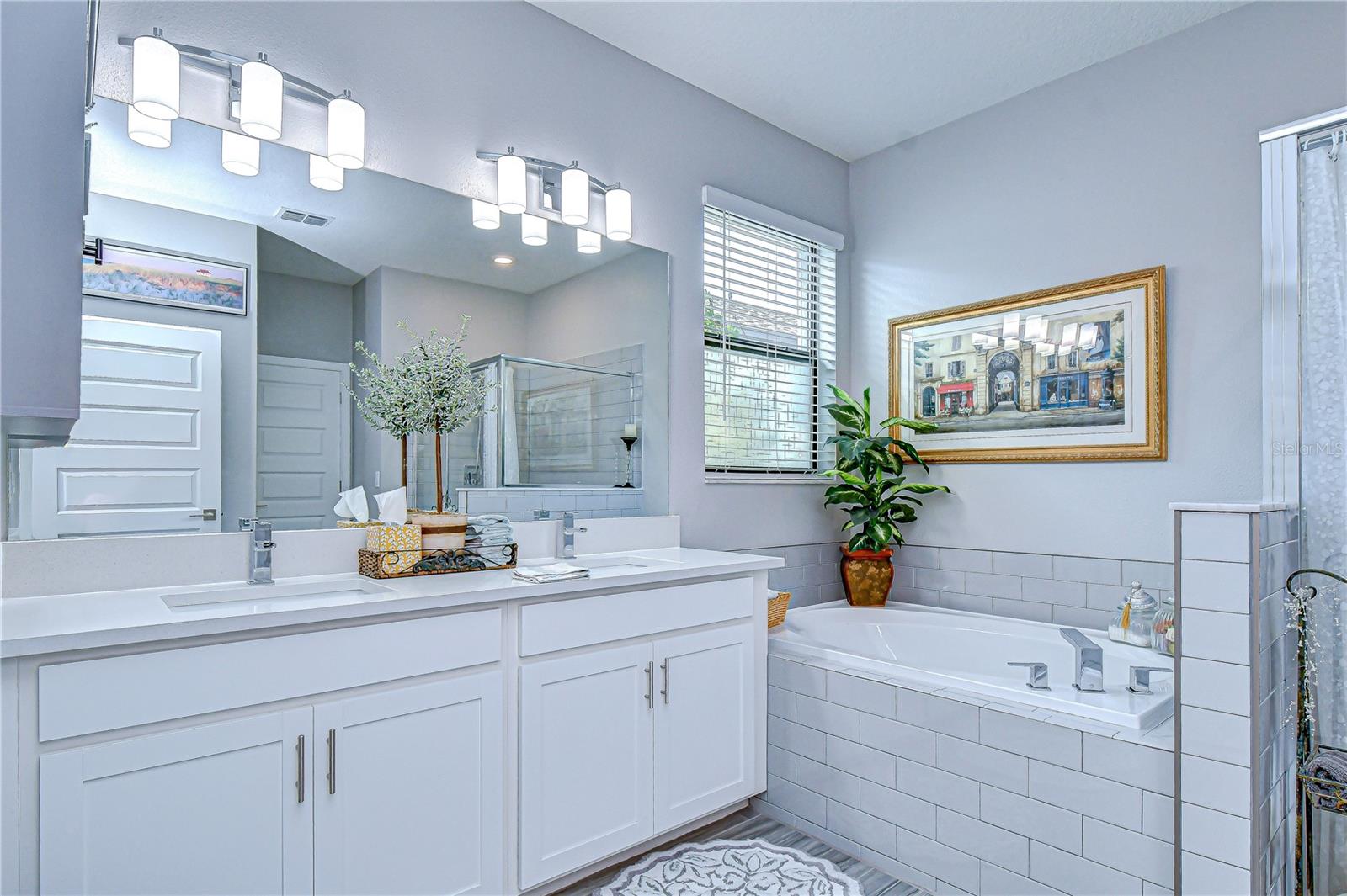 Spa-inspired bathroom featuring dual sinks and luxurious finishes.