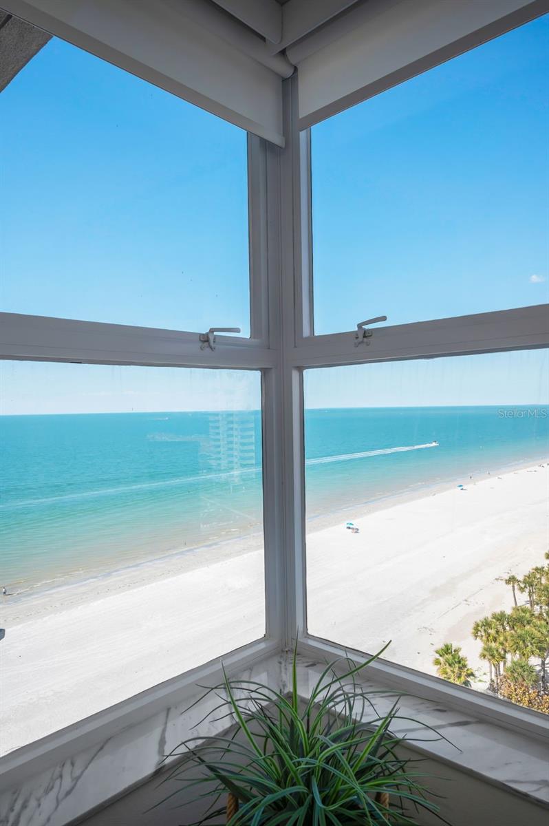 Large corner window in the living area overlooking the waterfront and northward down the beach