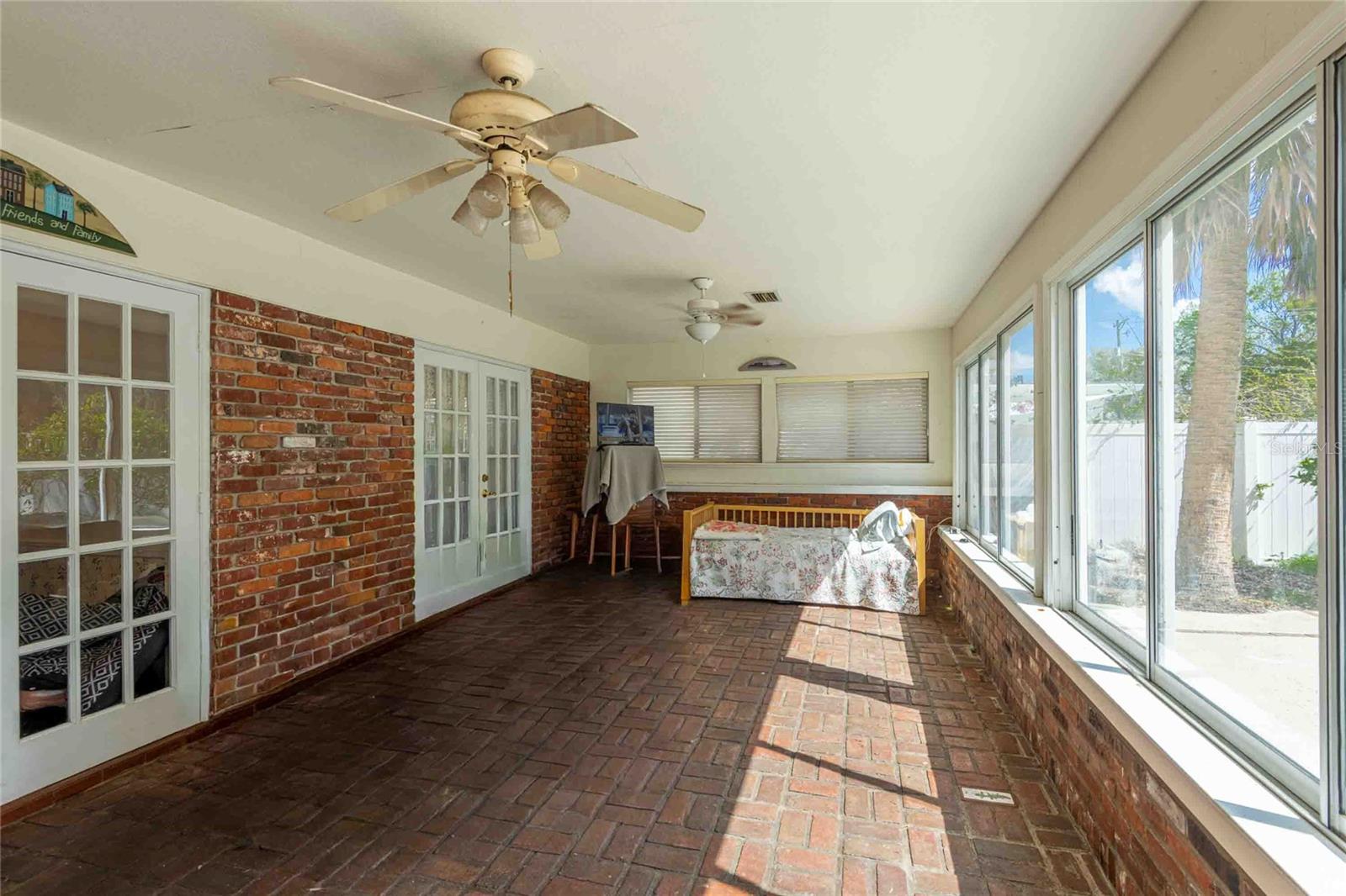 4  SEASON SUNROOM WITH BRICK FLOORING.