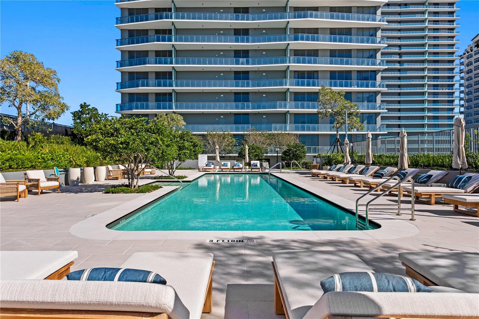 Pristine landscaped pool, deck and private cabanas