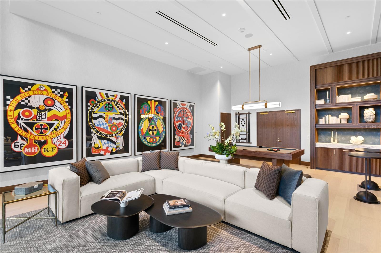 Resident Game Lounge with billiards table, media seating, and large-screen TVs