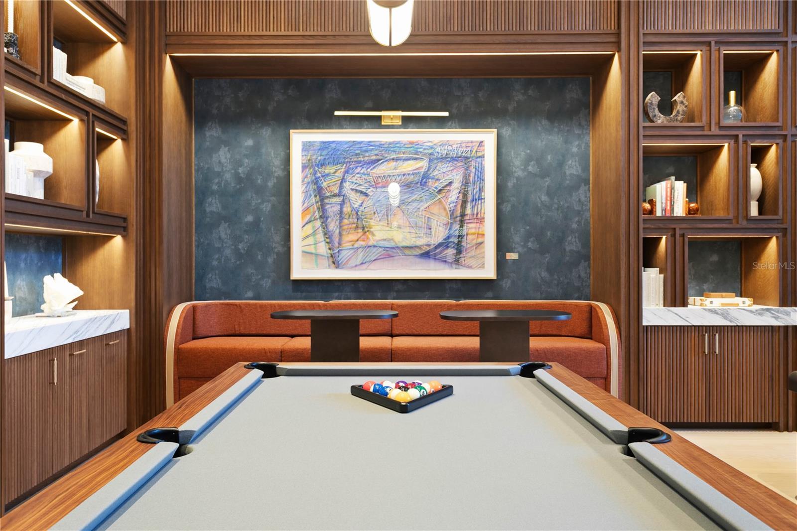 Resident Game Lounge with billiards table, media seating, and large-screen TVs