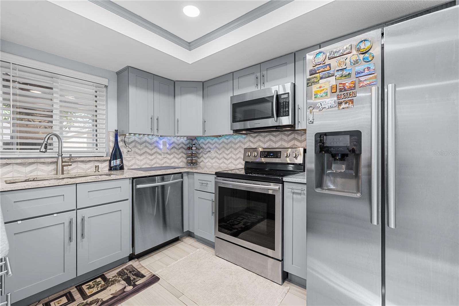 Gorgeous Shaker style cabinetry, stainless steel appliances, and granite countertops in the kitchen