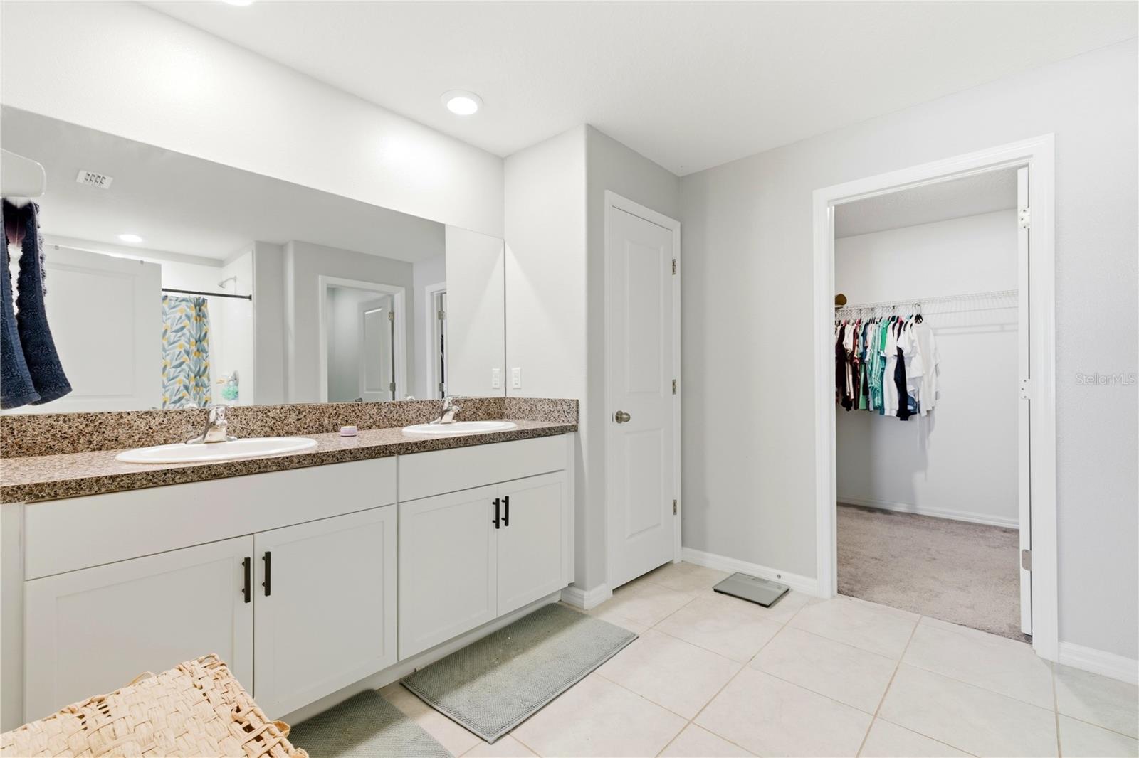 Large ensuite bath with double vanity and huge walk in closet offers space to spread out