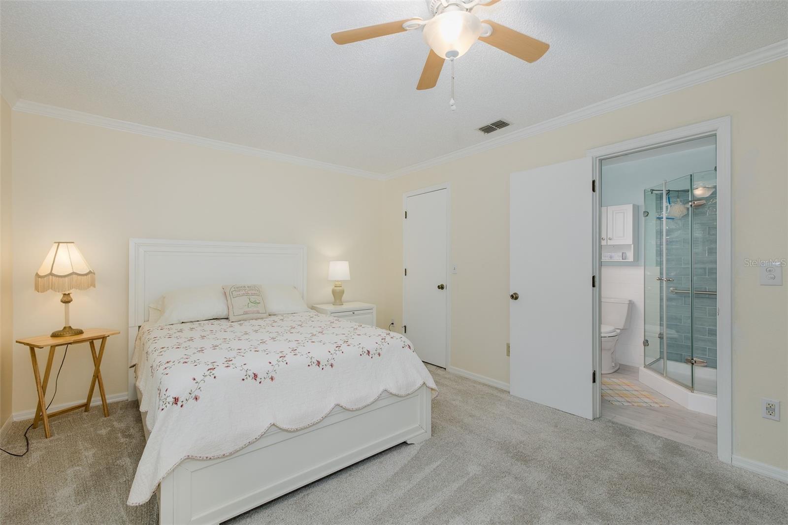 Primary bedroom with walk in closet and en suite bath