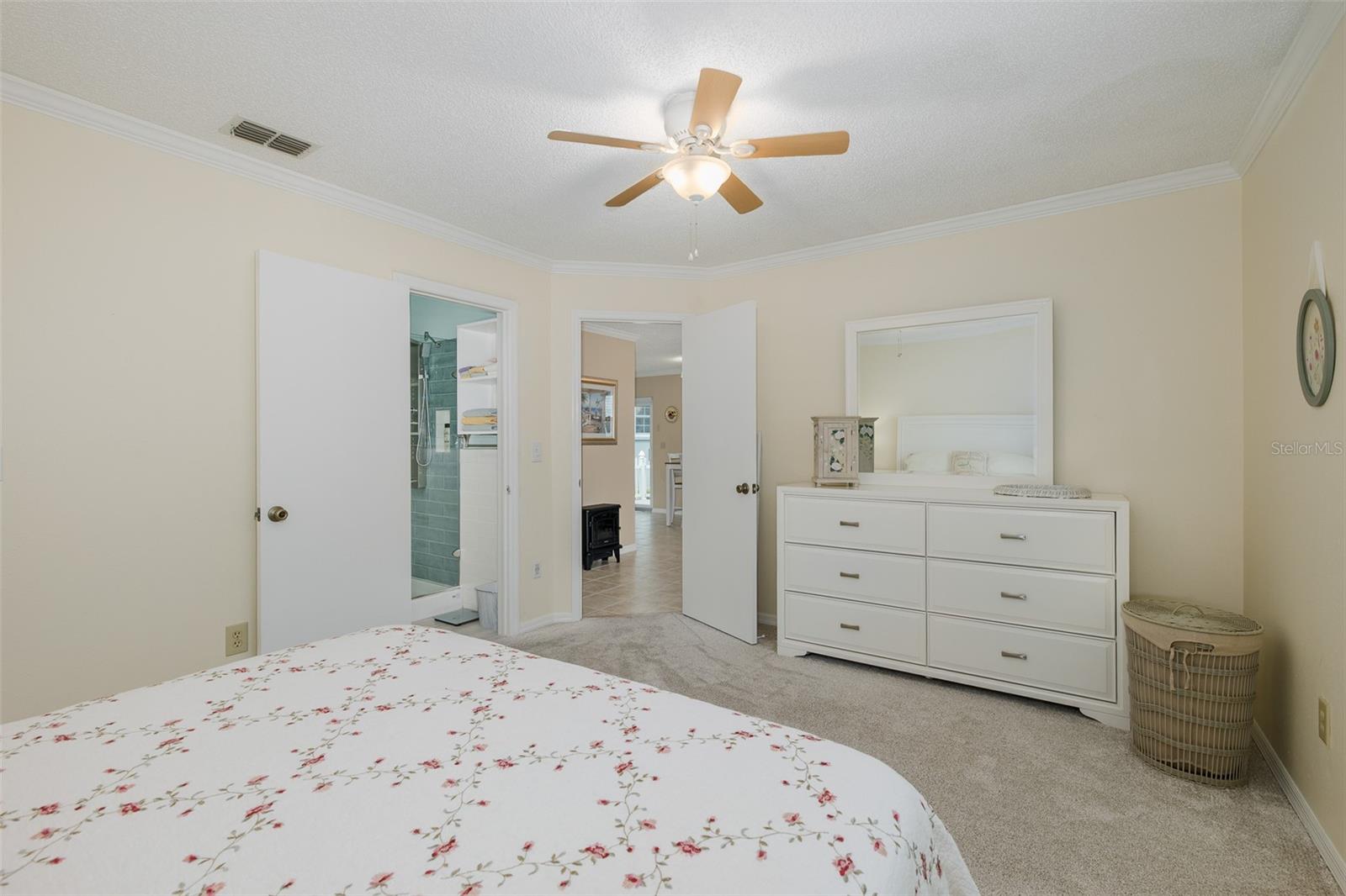 Primary bedroom with walk in closet and en suite bath
