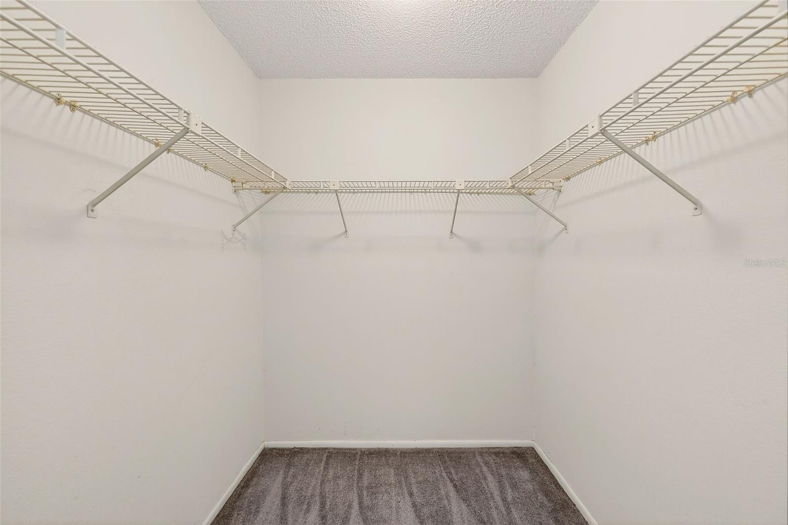 Primary bedroom walk in closet