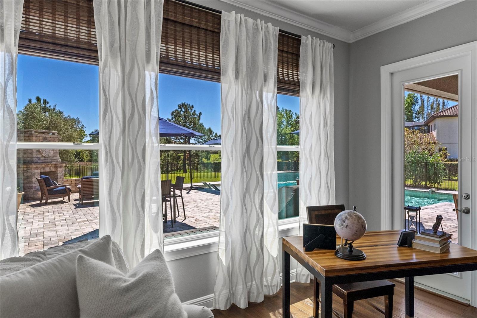 View of Pool, spa and fireplace from the primary suite