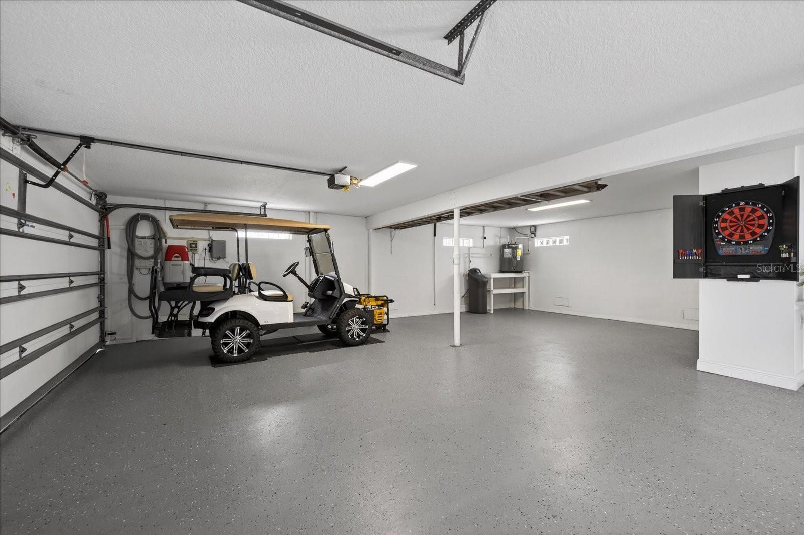 3 car garage showing water softener system and Hot water heater plus wall mounted car vac