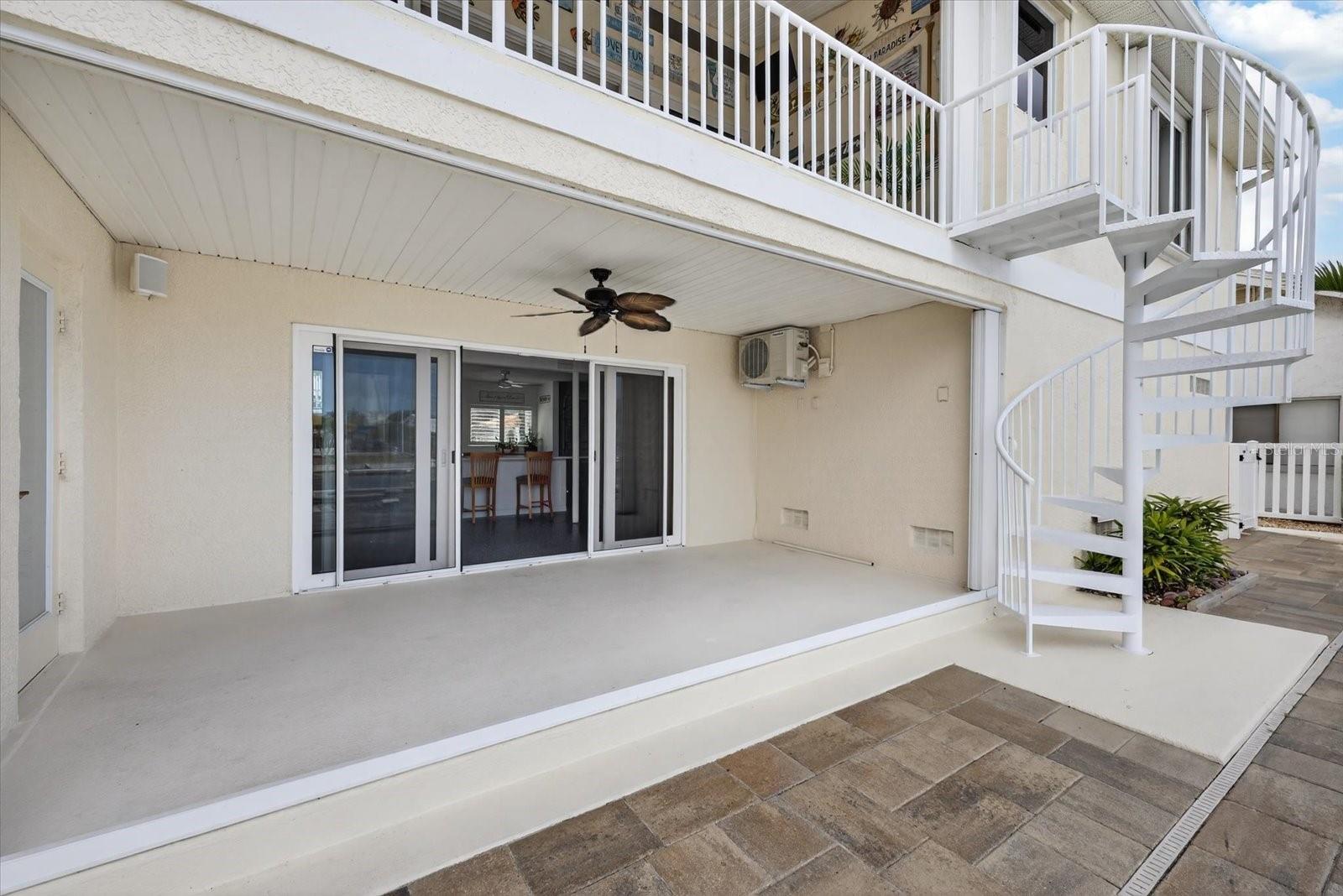 Lower patio with spiral staircase to upper balcony