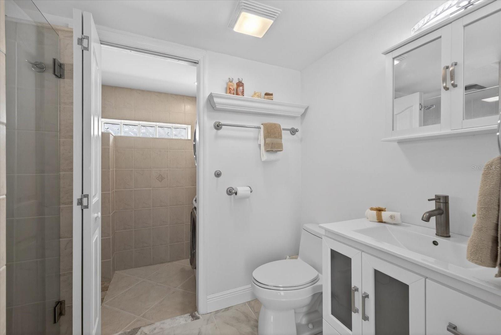 Lower level has step up full n bathroom leading to laundry room.