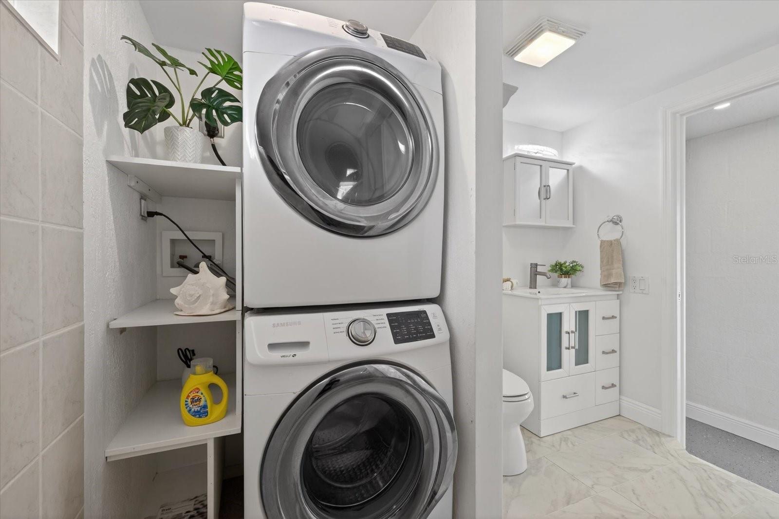 Lower level view of step up laundry room and full bathroom