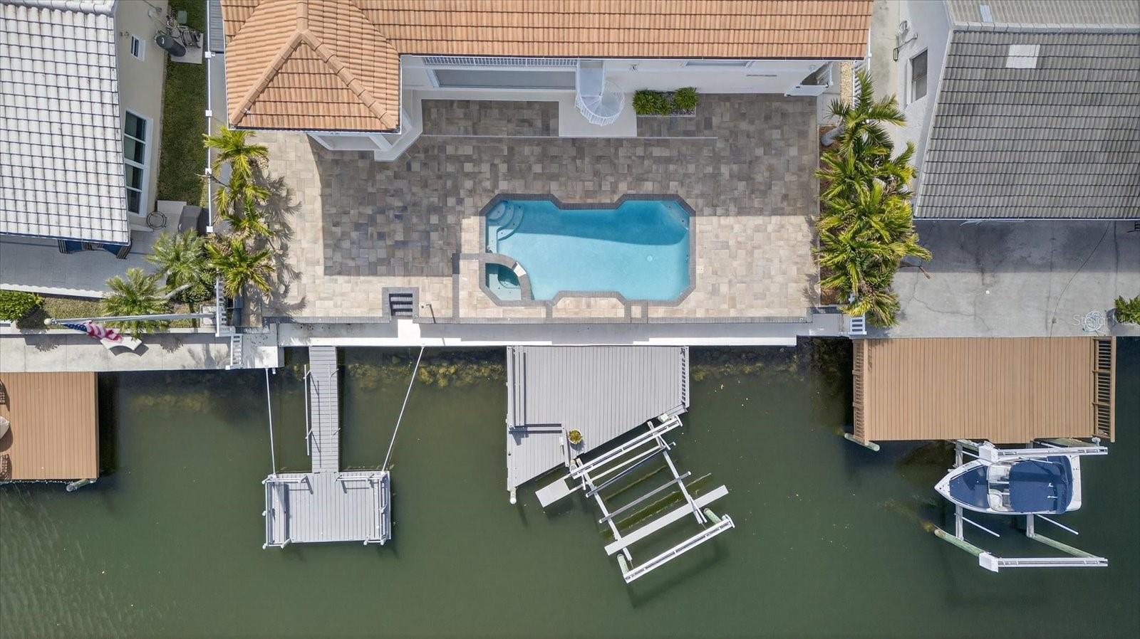 Aerial backyard waterfront views of Pool, dock and boat lift