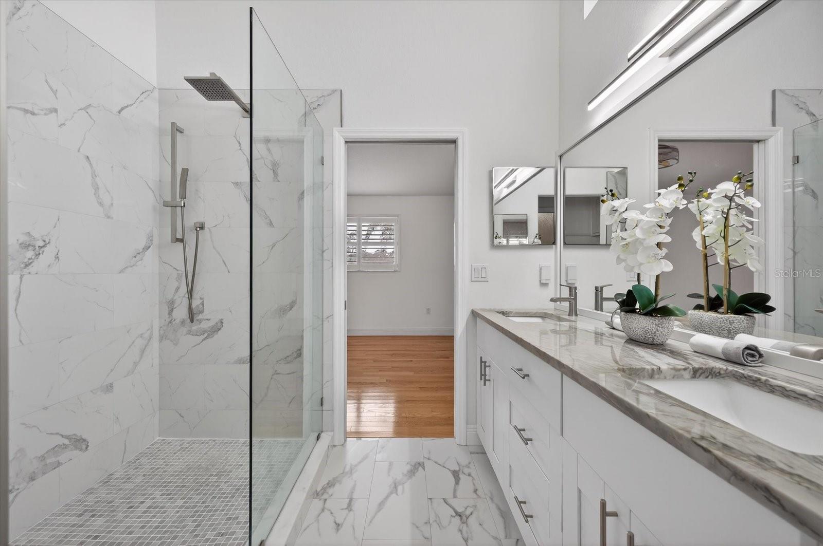 Primary Bathroom with double vanity looking into Primary bedroom