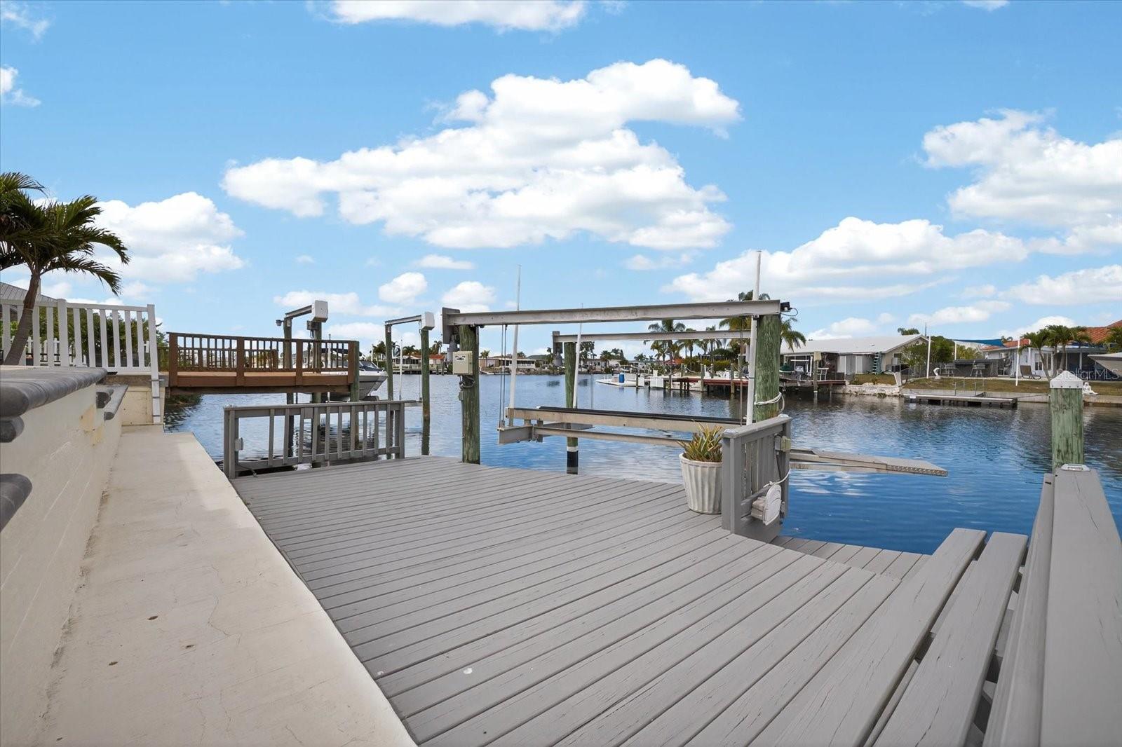 10,000 lb boat lift and stationary dock.