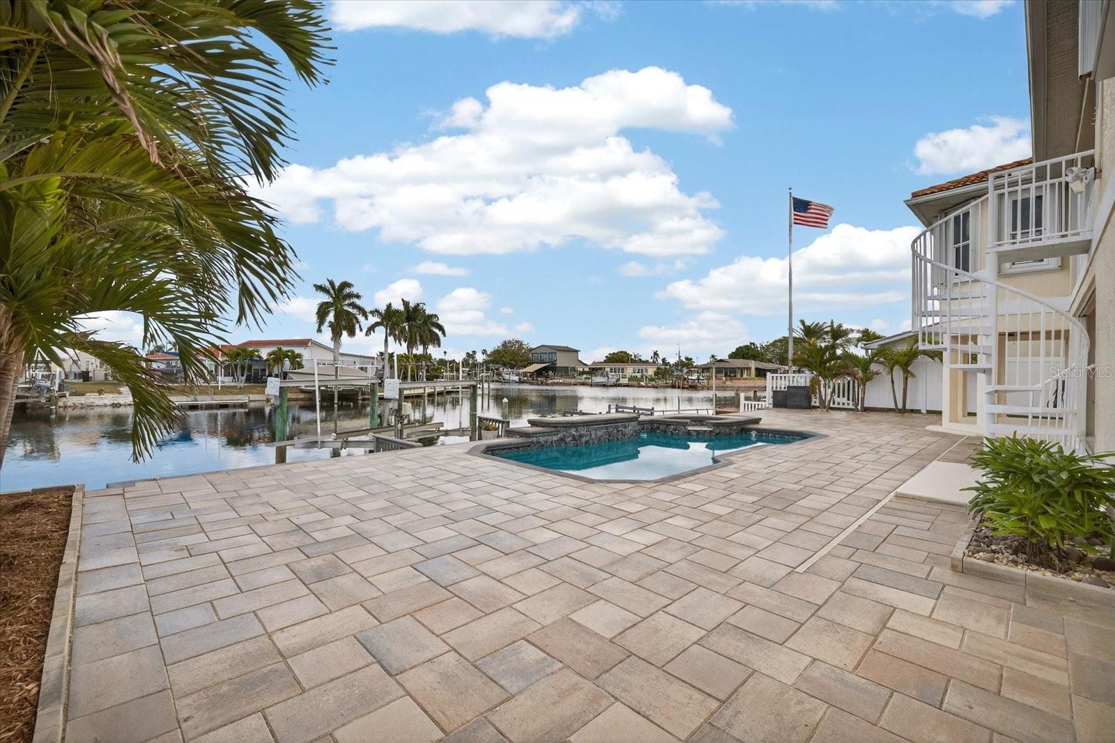 Large PAVERED backyard entertainment space around pool/spa