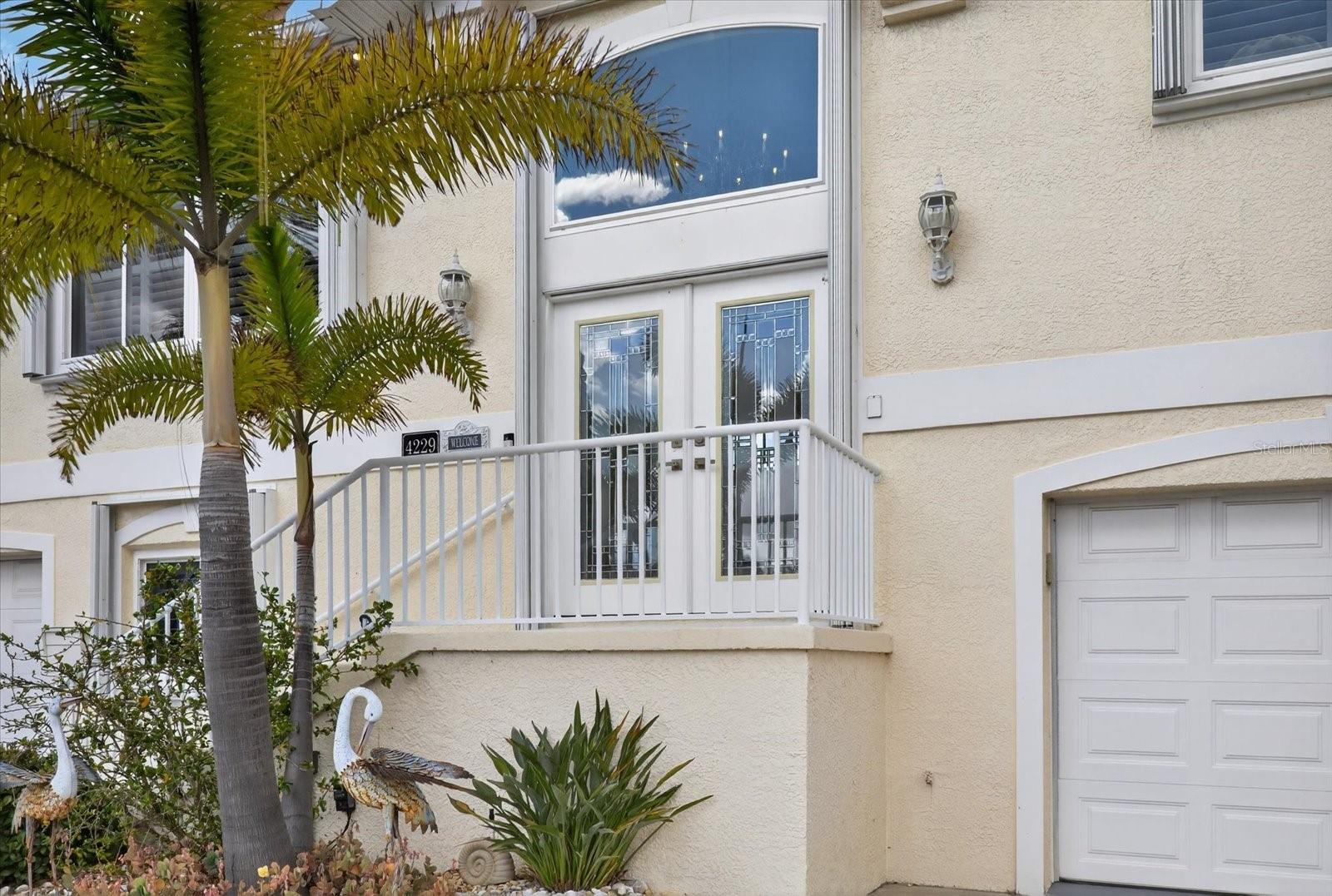 Elevated front entry with elegant French doors.