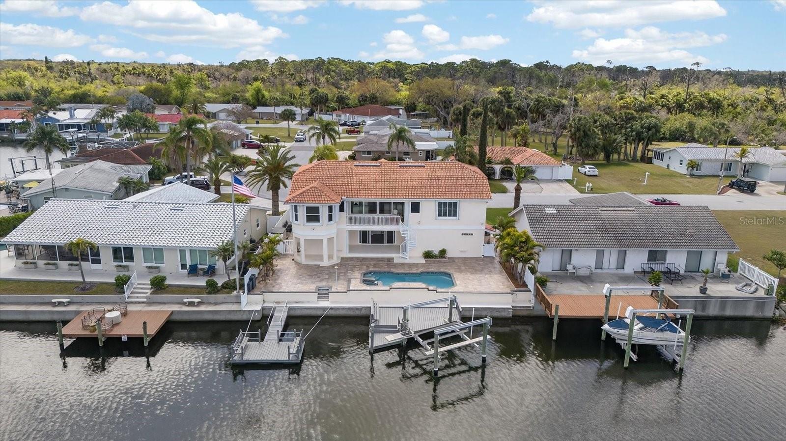 Aerial view of home from the water of the wide deep channel to the GULF. Looking south.