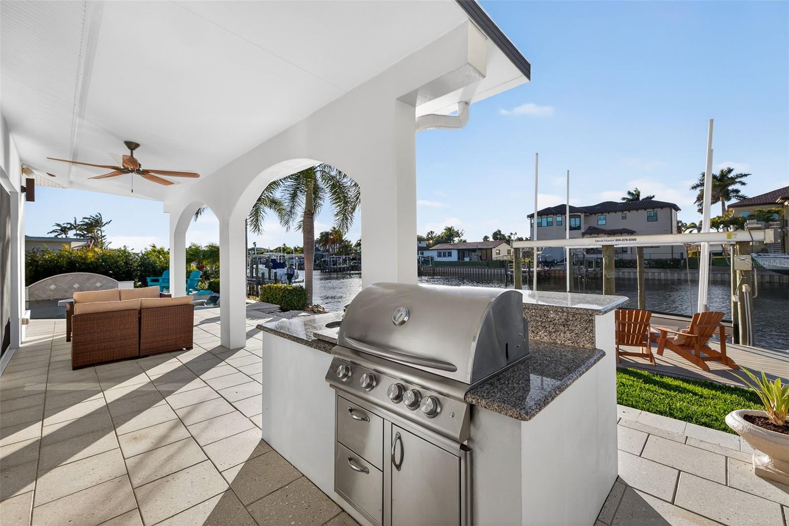 Outdoor living area with  gas grill with lifetime warranty, prep area and sink.