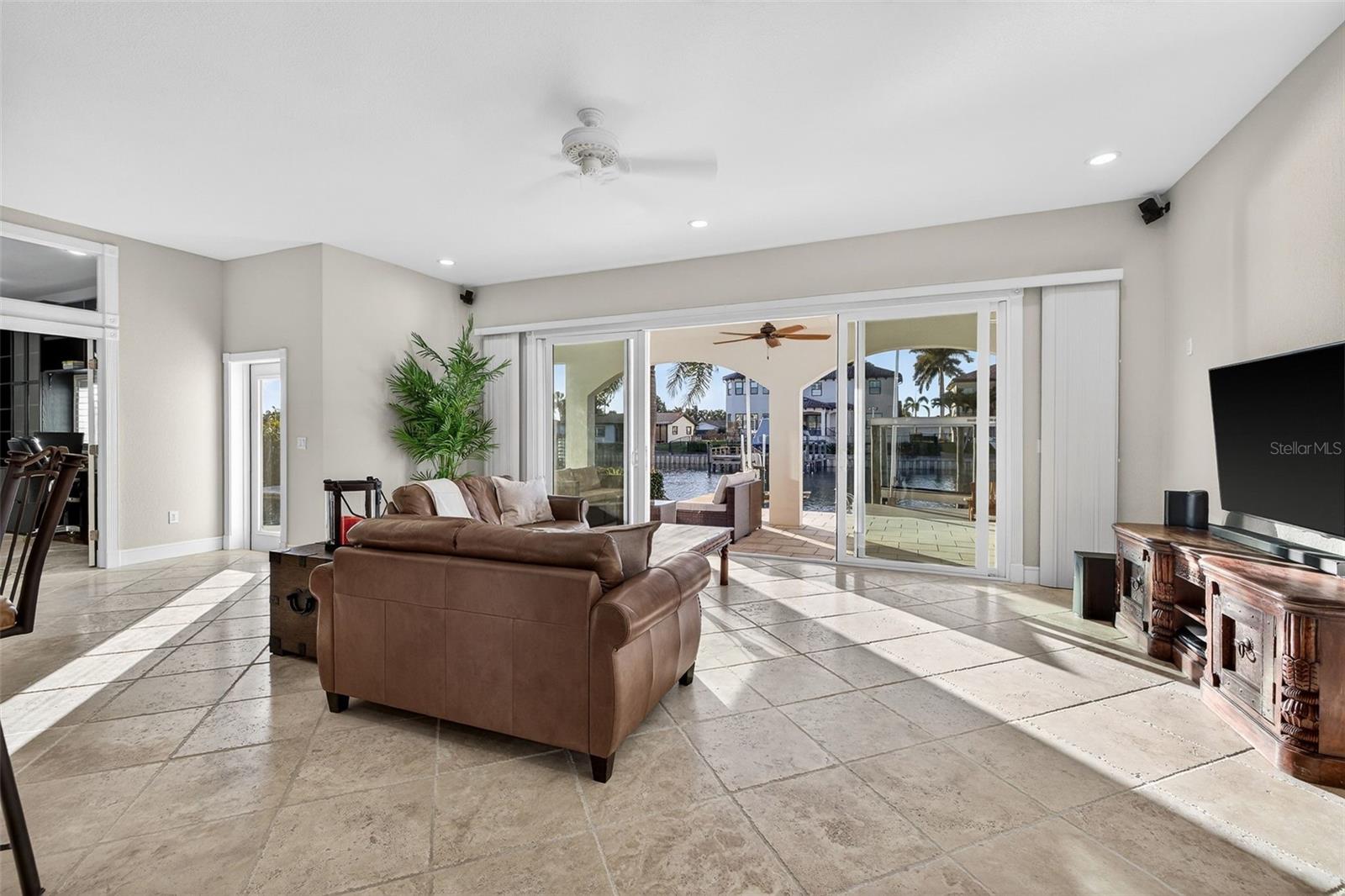 Family area with views to the water with 10' ceilings and Italian travertine throughout