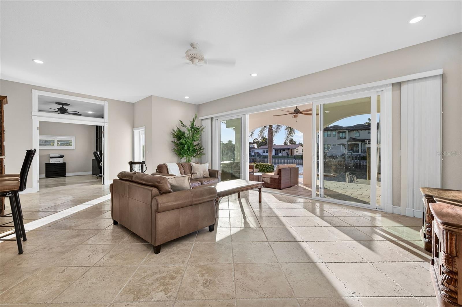 Family area with views to the water with 10' ceilings and Italian travertine throughout