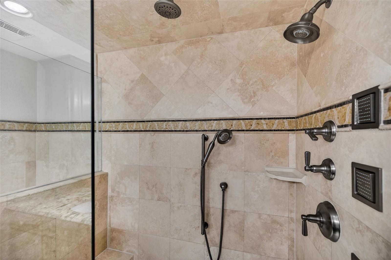 Multiple shower heads in primary bathroom.