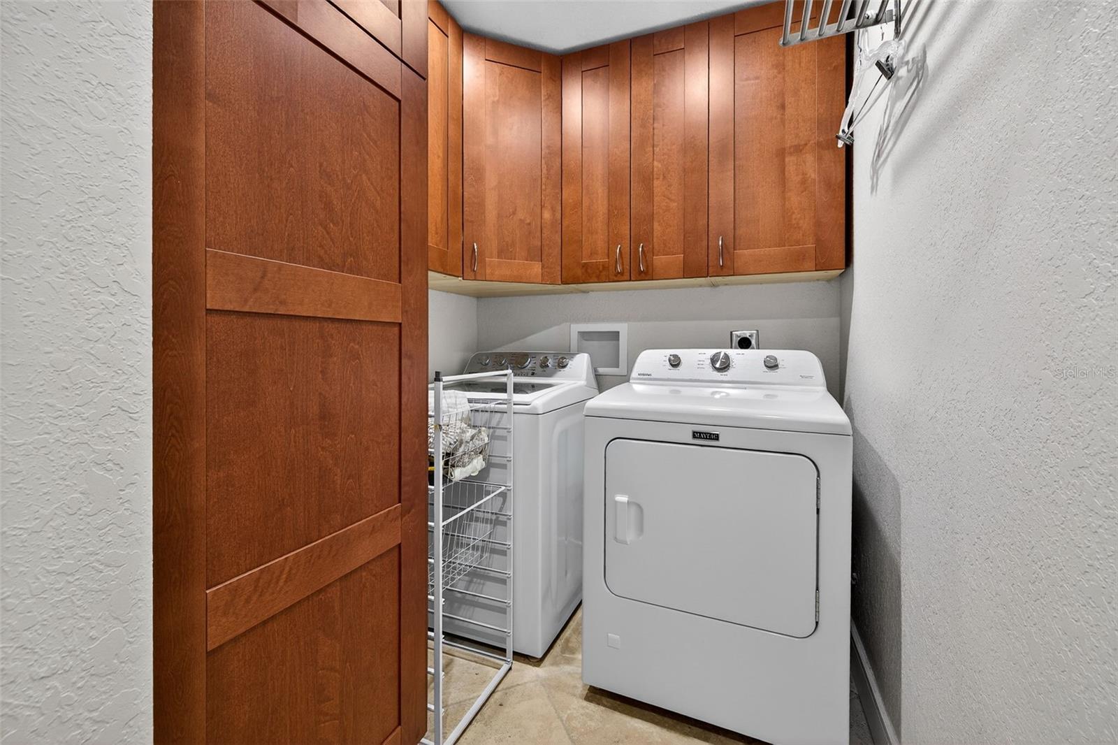 Laundry closet with cabinets. Gas dryer.