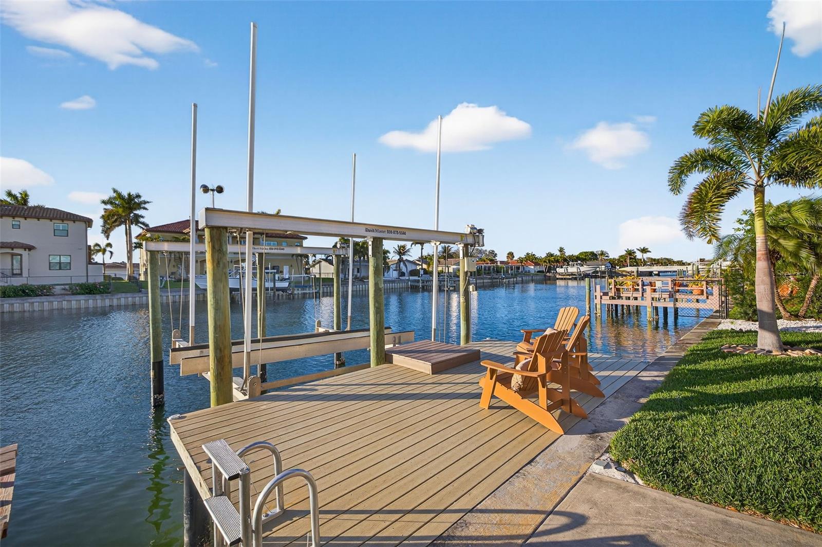 Additional sitting area on Dock with 20,000lb boat lift and jet ski lift.