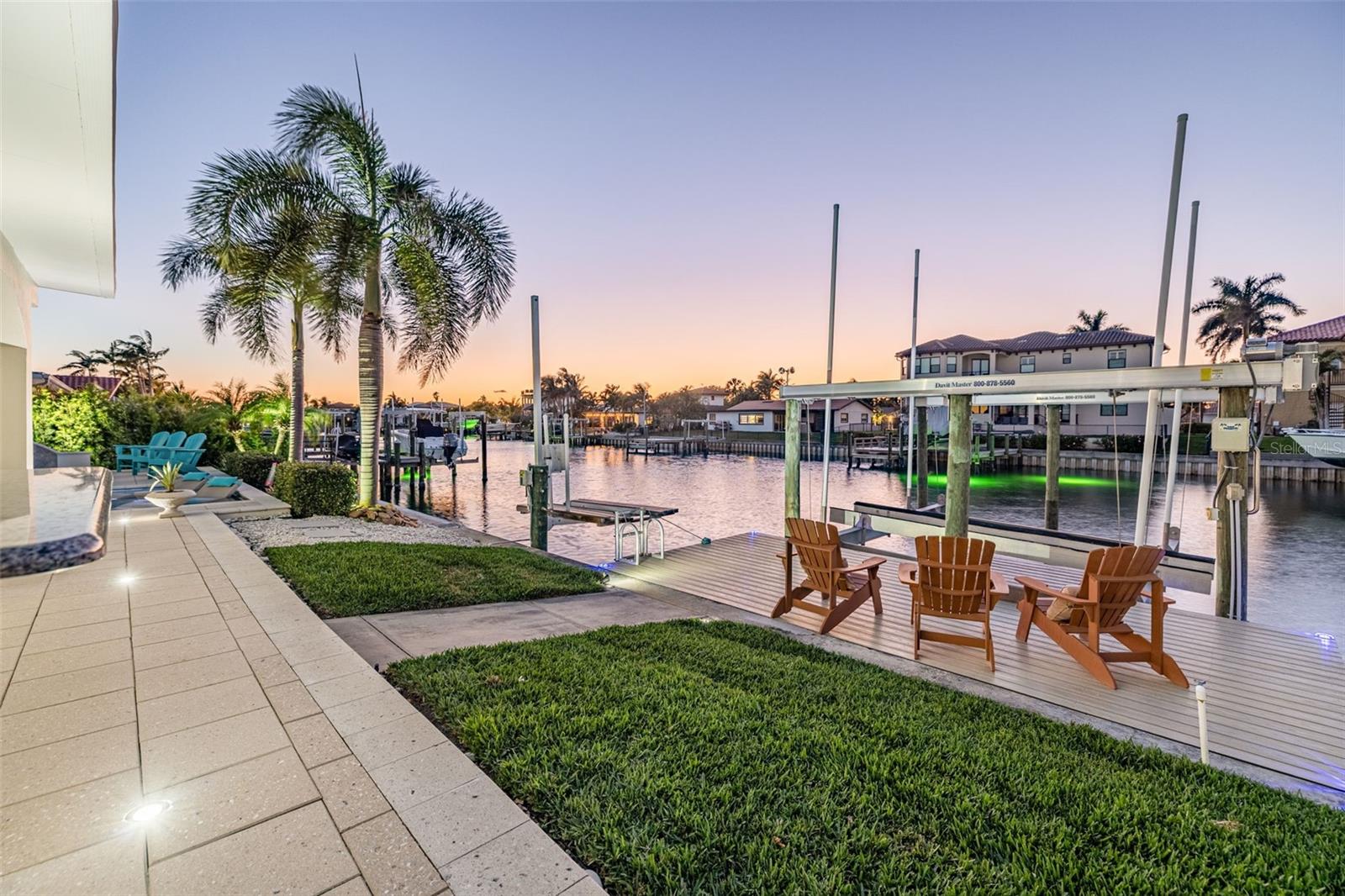 Additional sitting area on Dock with 20,000lb boat lift and jet ski lift. Equipped with electrical and water.