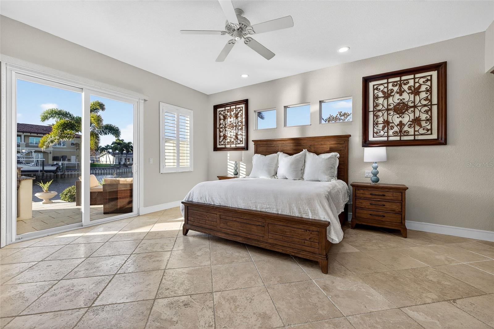 Primary Bedroom with access to the oudoor living area. 10' Ceilings and built-in wardrobe.